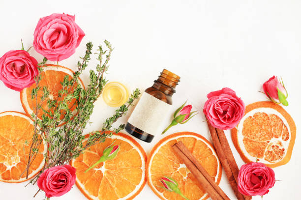istock Essential oil blend with orange fruit dried slices, fresh rose blossom, thyme herb. 1133419783