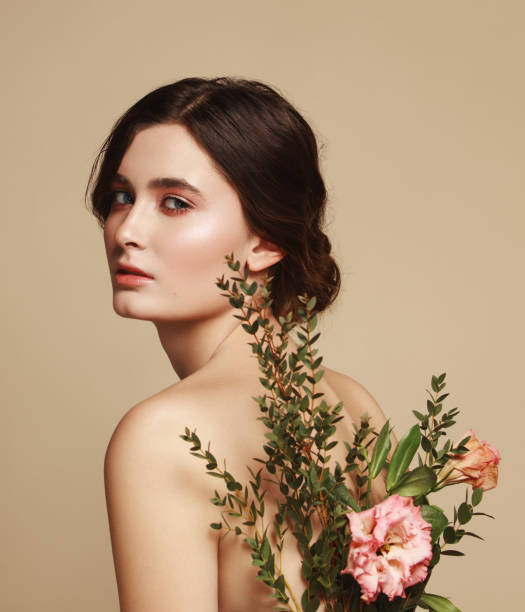 istock Young beautiful girl and flowers 1133422863