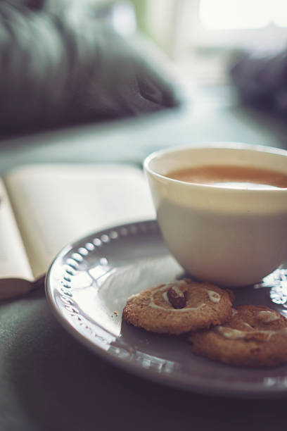 Crumpled bedding with tea and book for a relaxing day