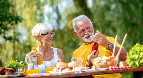 istock Senior couple having lunch outdoors 1133423180