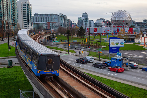 Downtown Vancouver, British Columbia, Canada - November 29, 2018: Skytrain passing in the modern city during a cloudy evening.