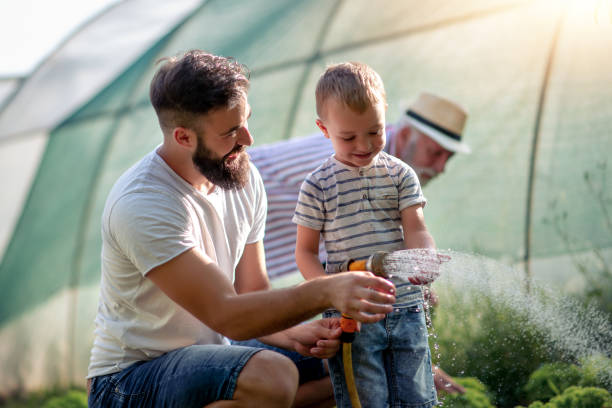 istock Young father with his son working in the garden 1133426449