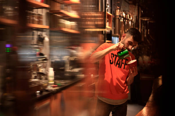 Barista Making Coffee For Customers At Cafe