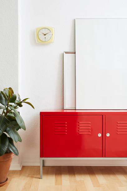 istock minimaist interior design large picture frames on red locker with clock and plant 1133431082