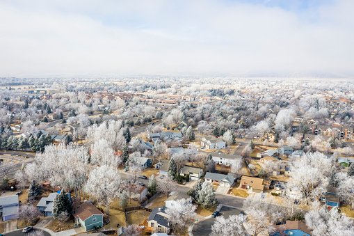 hazy and frosty winter morning over city of Fort Collins and foothills of Rocky Mountains in Colorado, aerial view