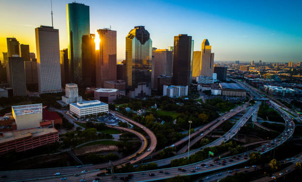 Drone sunrise cityscape of Houston Texas major urban city Houston Texas aerial drone view with traffic morning drivers and highways and interstates in and out of downtown urban sprawl sunrise golden hour houston skyline stock pictures, royalty-free photos & images