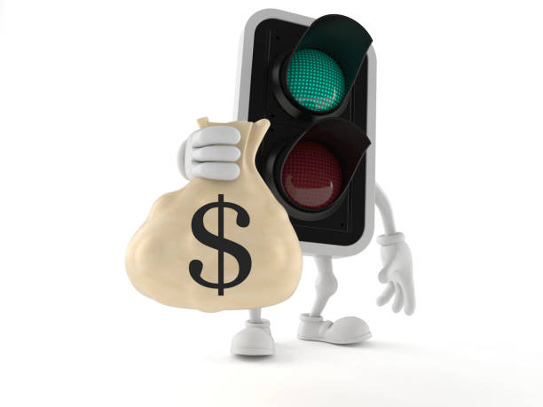 istock Green traffic light character holding money bag 1133437172
