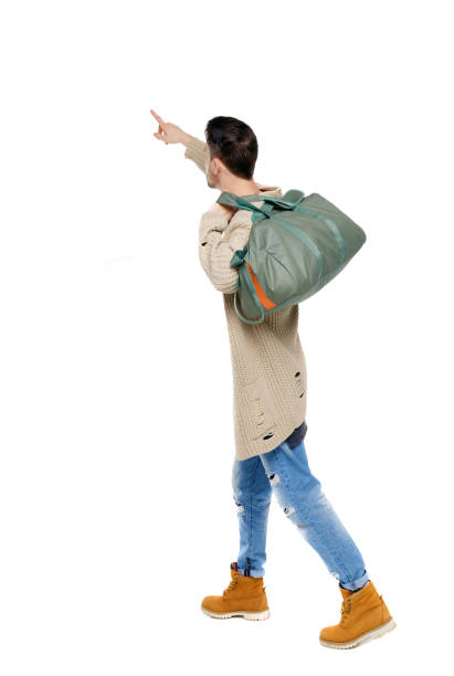 istock Side view of a walking man with a bag pointing his hand up. 1133438035