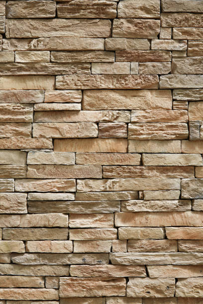 istock Wall of stone beige surface bricks as a background. 1133439336