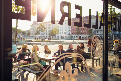 Copenhagen, Denmark - September 15, 2014: People sitting in sidewalk cafe on Israels Plads in Copenhagen, Denmark.