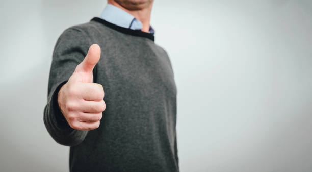 istock Showing thumb up. The man stretches his hands out with his thumb raised. 1133441661
