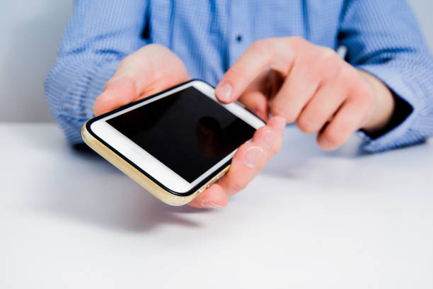 istock White telephone with empty, blank screen in the hand. 1133441833