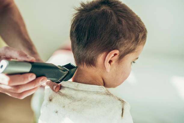 Toddler getting haircut Shot of cute little boy getting haircut kids barber stock pictures, royalty-free photos & images