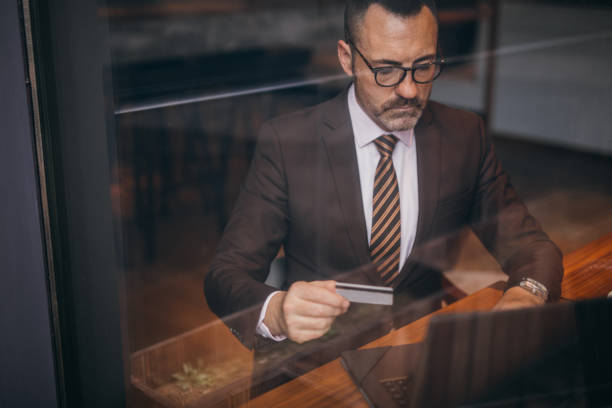 istock Elegant senior man is using credit card 1133443222