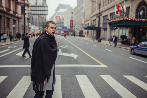 istock Stylish guy crossing the street 1133445461