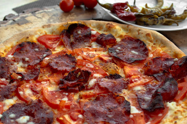 istock Pizza with chilli peppers, peppers, fresh tomatoes and yellow cheese. Closeup. 1133446531