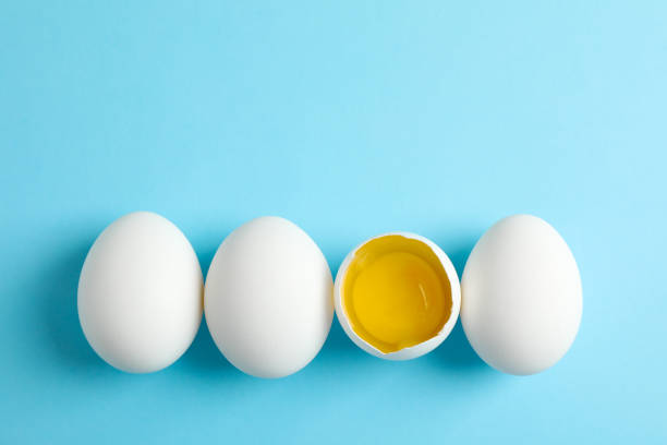istock Chicken eggs and half with yolk on color  background, space for text 1133446727