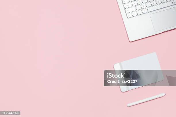 Modern Workspace Of Photographer Illustrator Or Designer Pink Table With Laptop Graphic Tablet With Pen Top View Flat Lay Template With Copy Space Stock Photo - Download Image Now