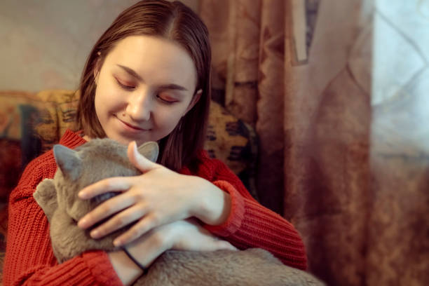 istock Happy girl with her cat indoors 1133452245