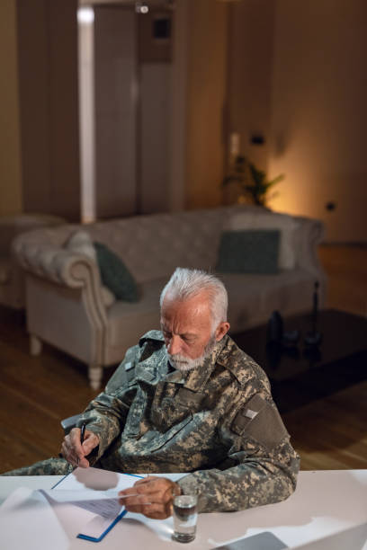 istock Mature army soldier filling documents in the office. 1133452380