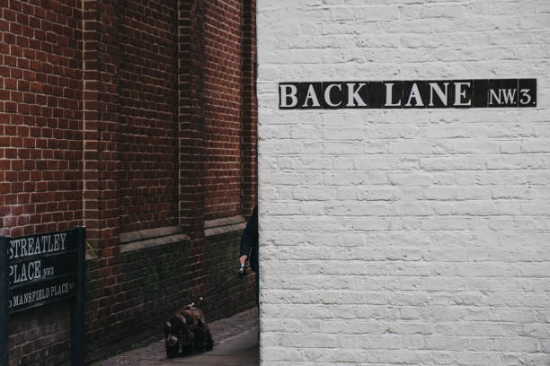 A man puts up new posters on a wall where many music and entertainment events are marketed.