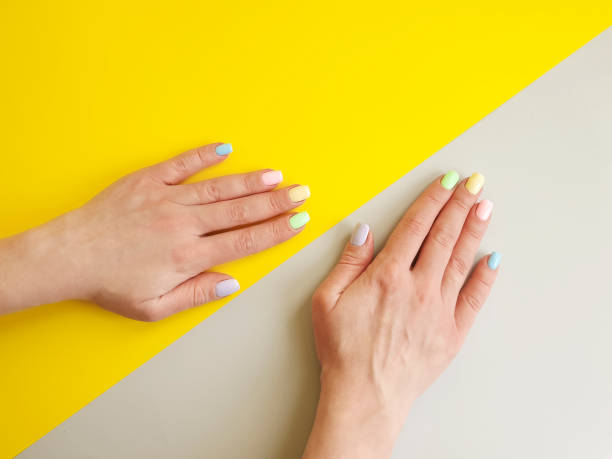 istock female hands manicure on colored paper 1133453382