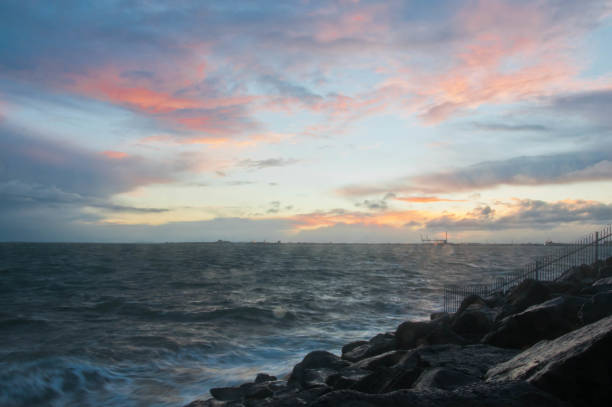 istock Dramatic splashing ocean wave in the evening with twilight sky in Winter at breakwater at St Kilda pier in Melbourne Australia 1133453555