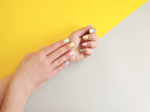 istock female hands manicure on colored paper 1133454339