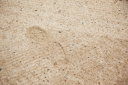 A golfer has left their footprint behind in the sand trap bunker