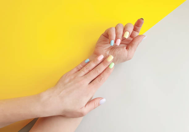 istock female hands manicure on colored paper 1133454734