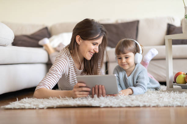 istock Happy mother using tablet pc with baby girl 1133455595