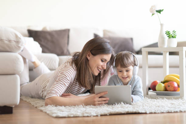 istock Happy mother using tablet pc with baby girl 1133455616