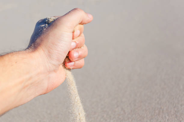 istock sand pours out of your hand 1133458441