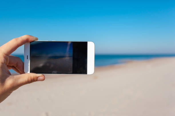 istock photographing a beautiful landscape on a smartphone 1133458446