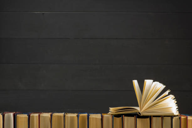 istock Open book, hardback books on wooden table. Back to school. Copy space. 1133458759