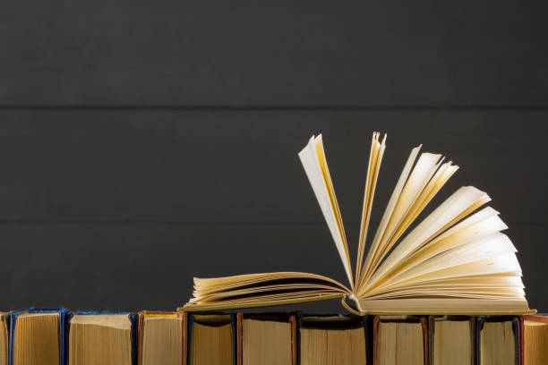 istock Open book, hardback books on wooden table. Back to school. Copy space. 1133458765