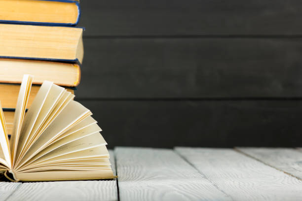 istock Open book, hardback books on wooden table. Back to school. Copy space. 1133458780