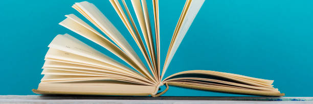istock Open book, hardback books on wooden table. Back to school. Copy space. 1133458817