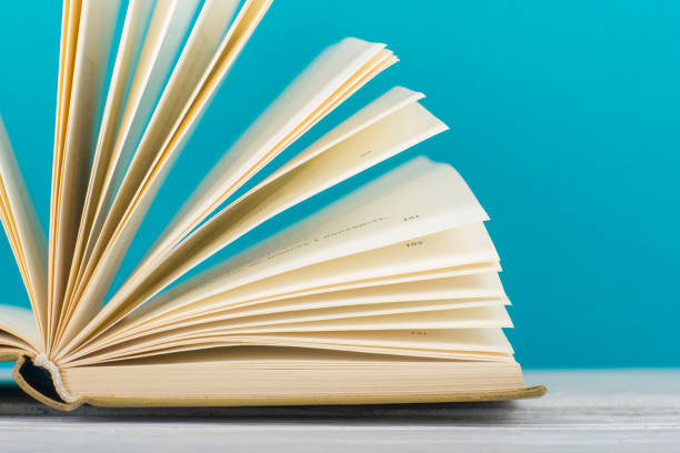 istock Open book, hardback books on wooden table. Back to school. Copy space. 1133458820