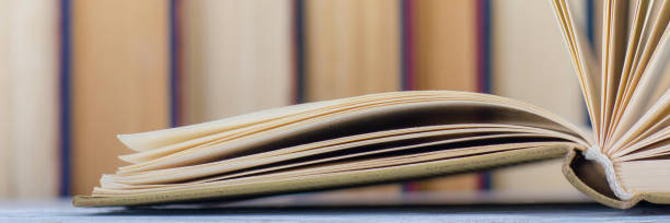 Open book, hardback books on wooden table. Back to school. Copy space.