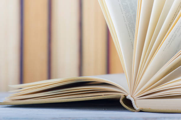 istock Open book, hardback books on wooden table. Back to school. Copy space. 1133458829