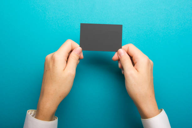 istock Hand holding white business card on white background 1133459833
