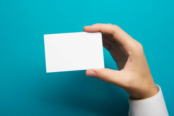istock Hand holding white business card on white background 1133459840