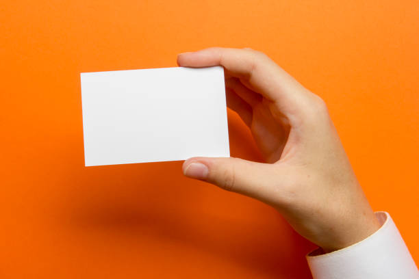 istock Hand holding white business card on white background 1133459845