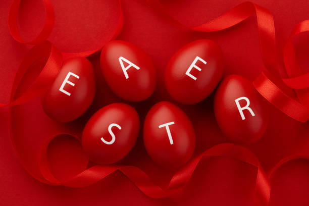 red easter eggs with letters arranged in a word - easter text single word paint imagens e fotografias de stock