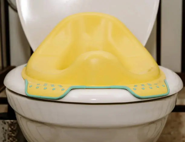 Photo of Toilet seat for children. The concept of teaching children to use the toilet, the next stage in the development of children.