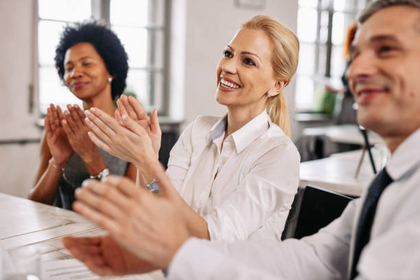 istock Smiling business colleagues applauding in the office. 1133466638