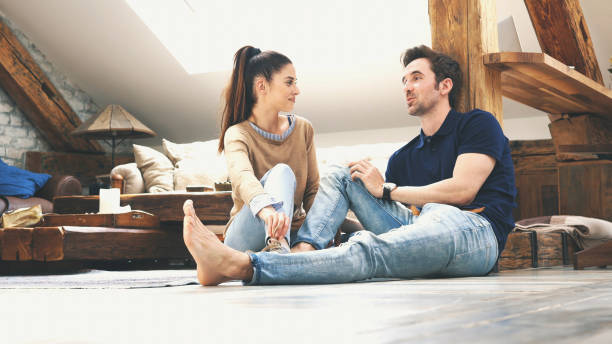 istock happy couple talking to each other at home 1133468187