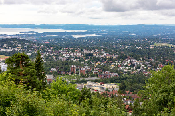 View on Oslo suburb from from Holmenkollen, Norway. Holmenkollen is a neighborhood in the Vestre Aker borough of Oslo, Norway. In addition to being a residential area, the area has been a ski recreation area since the late 19th century, with its famous ski jumping hill, the Holmenkollbakken, hosting competitions since 1892. To the north, the area borders to the woodlands area Marka.