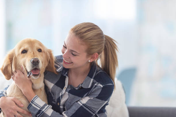 istock Smiling girl hugs her dog tight 1133468358